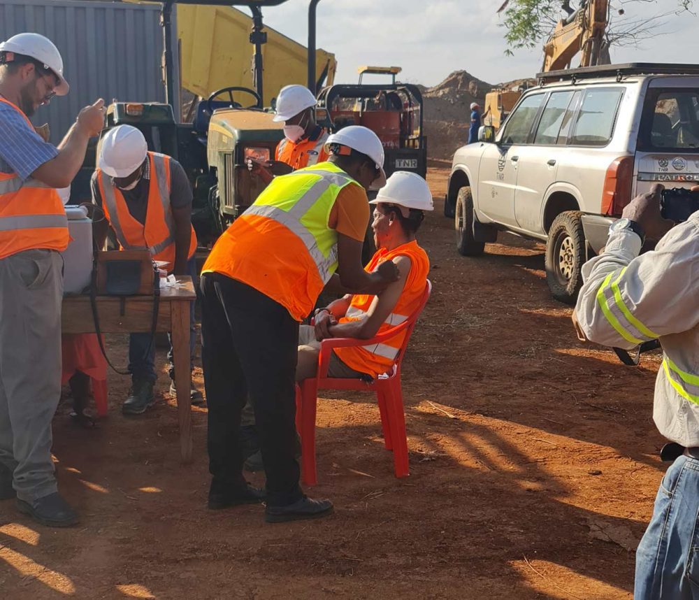 a worker receiving a covid vaccination on site